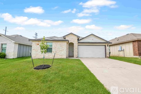 A house with a well-maintained lawn and a swing set in the yard.
