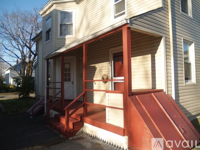 A house with a red staircase leading to the front door.