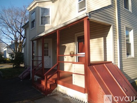 A house with a red staircase leading to the front door.