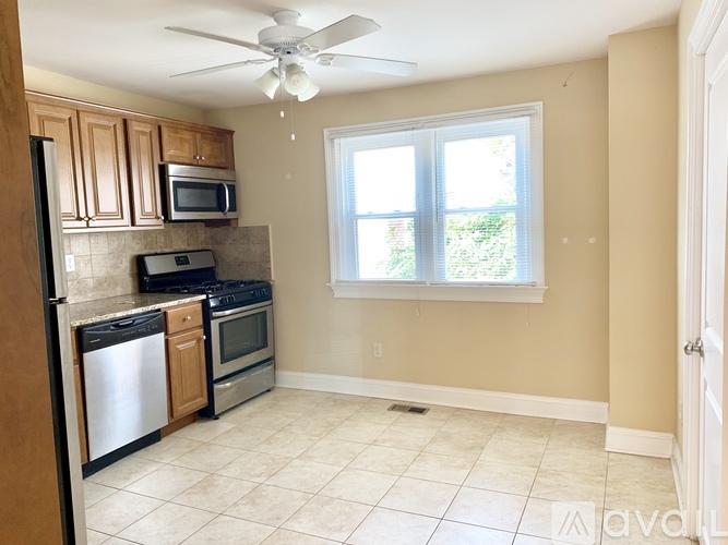A kitchen with a refrigerator, oven, microwave, and dishwasher.