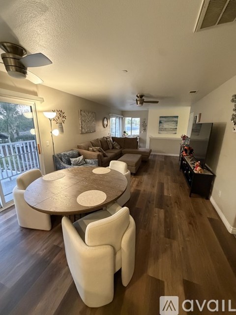 A living room with a round table and chairs.