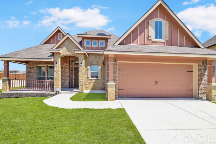A house with a brown roof and a pink garage door.
