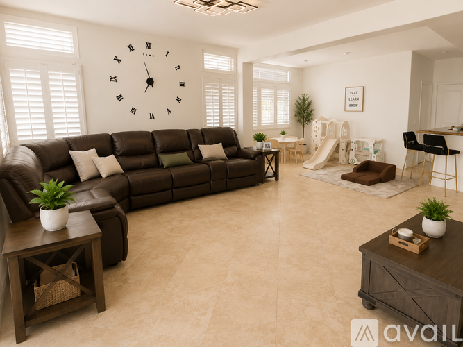 A living room with a large brown sofa and a clock on the wall.