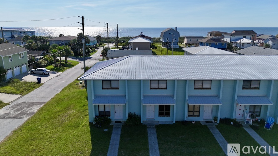 A row of houses with a sign that says "available" in front of one of them.