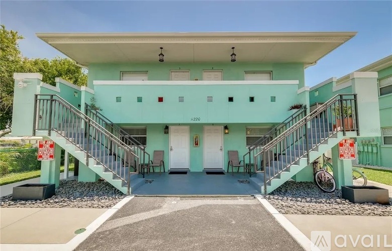 A two-story house with a balcony on the second floor.