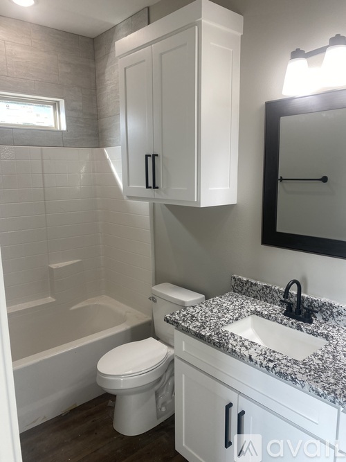 A white toilet sits next to a sink in a bathroom.