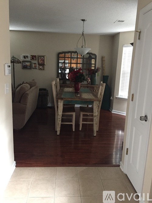 A dining room with a table and chairs.