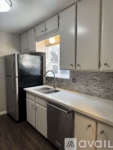 A kitchen with a stainless steel refrigerator and a dishwasher.