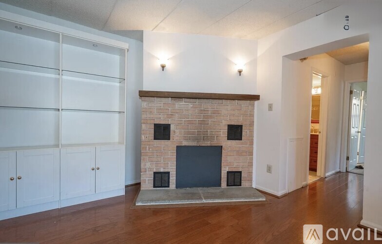 A living room with a fireplace and a television.