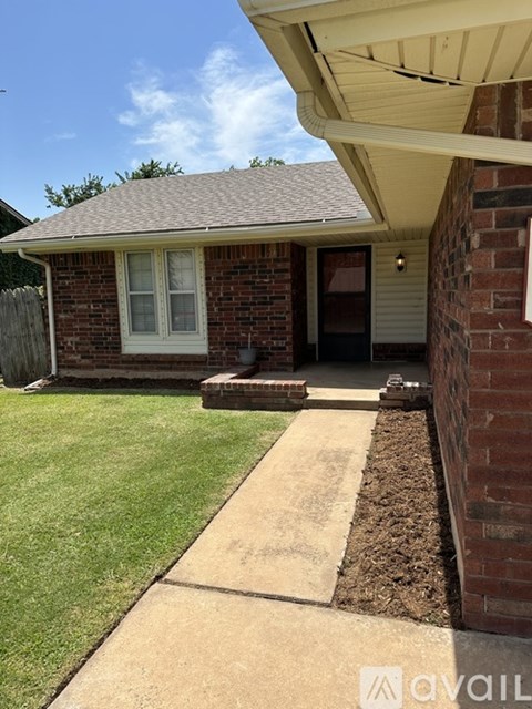 A house with a brick wall and a white door.