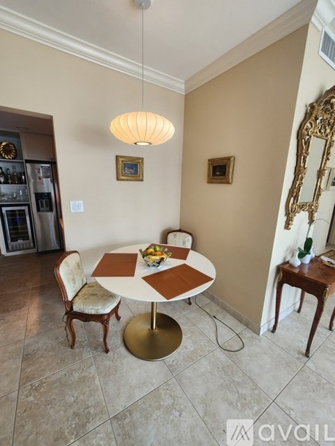 A dining room with a round table and chairs.