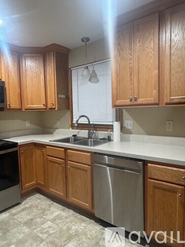 A kitchen with wooden cabinets and a sink.