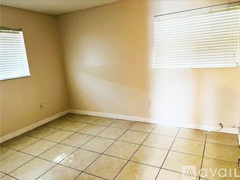 A room with beige walls and tiled flooring is available for rent.