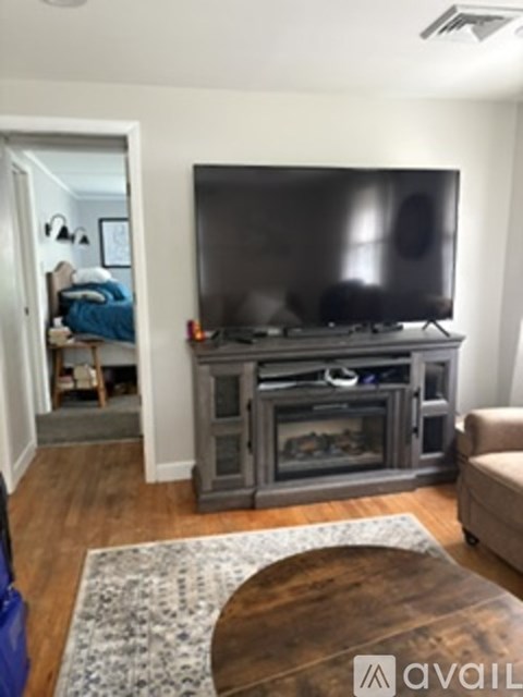 A living room with a television and a coffee table.
