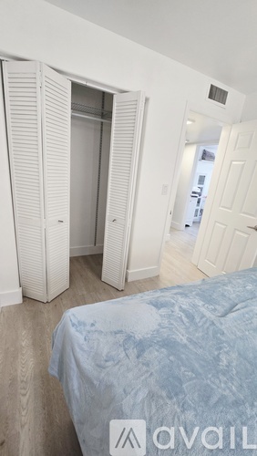 A bedroom with a bed and a wardrobe.