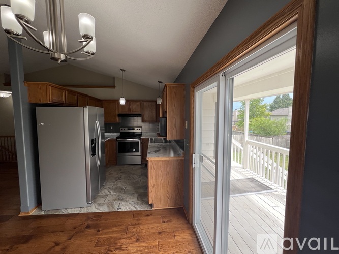 A kitchen with a refrigerator, oven, and sink.