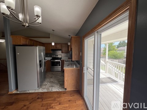 A kitchen with a refrigerator, oven, and sink.