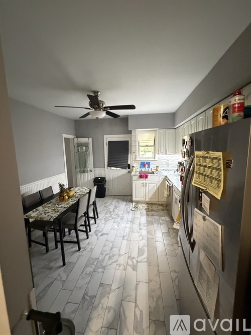 A kitchen with a dining table and chairs.