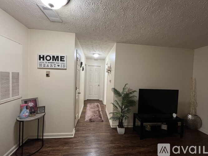 A living room with a sign on the wall that says "HOME".