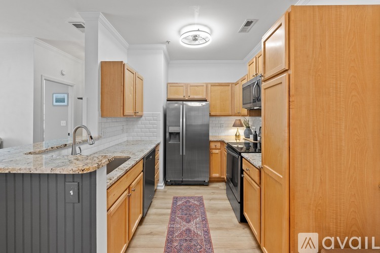 A kitchen with wooden cabinets and a granite countertop.