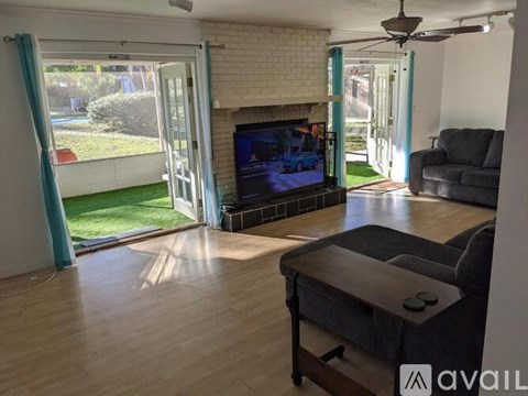 A living room with a television and a fireplace.