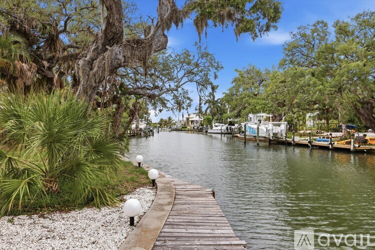 A wooden walkway leads through a lush green landscape.
