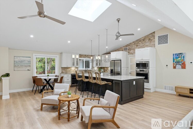 A modern kitchen with a dining table and chairs.