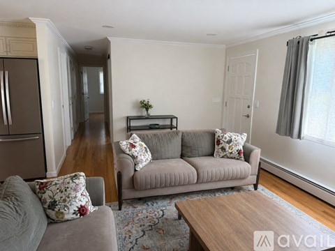 A living room with a grey couch and a wooden coffee table.