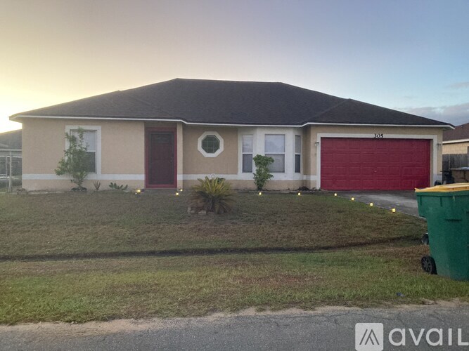 A house with a red garage door is for sale.