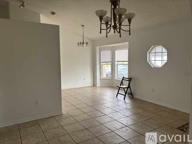 A room with a tiled floor and a chandelier.