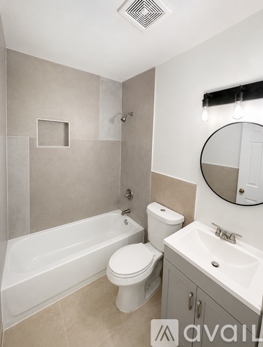 A bathroom with a white toilet, sink, and bathtub.
