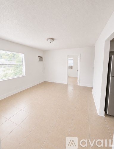 A kitchen with a dishwasher and a window.
