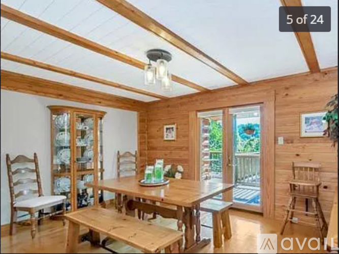 A wooden dining room with a table set for four.