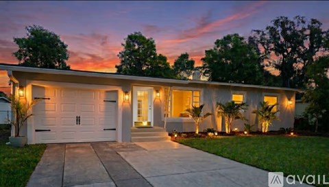 A house with a driveway and garage is available for sale.