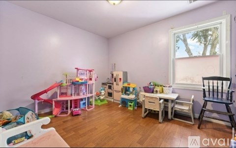 A child's playroom with a slide, toys, and a window.