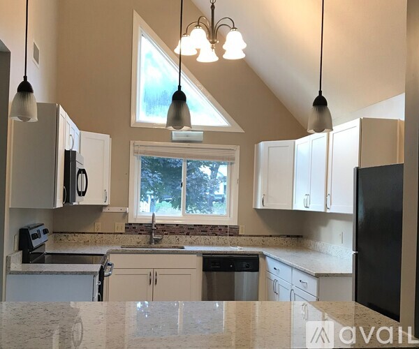 A kitchen with a window above the sink.