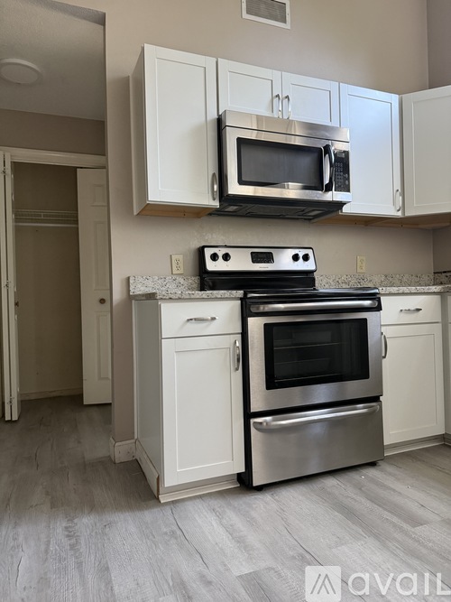 A kitchen with a stove, oven, and microwave.