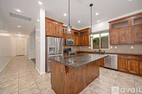 A kitchen with wooden cabinets and a central island.