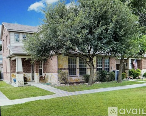 A house with a tree in front of it.