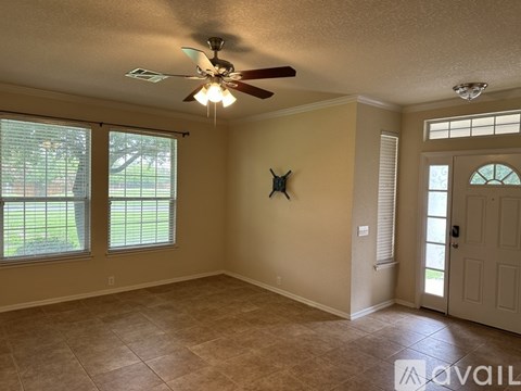 A room with a ceiling fan and a star decoration on the wall.