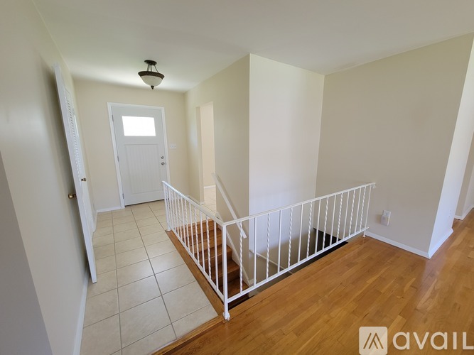 A white door is in the middle of a hallway.