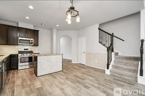 A kitchen with a stove top oven and microwave.