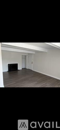 A room with a dark brown sofa and a white door.