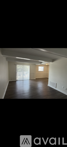 A room with wooden floors and white walls.