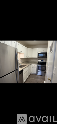 A kitchen with white cabinets and stainless steel appliances.