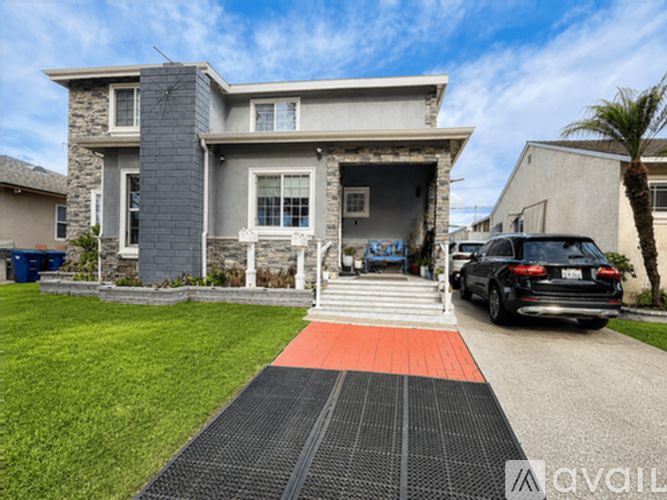 A house with a driveway and a car parked in front.