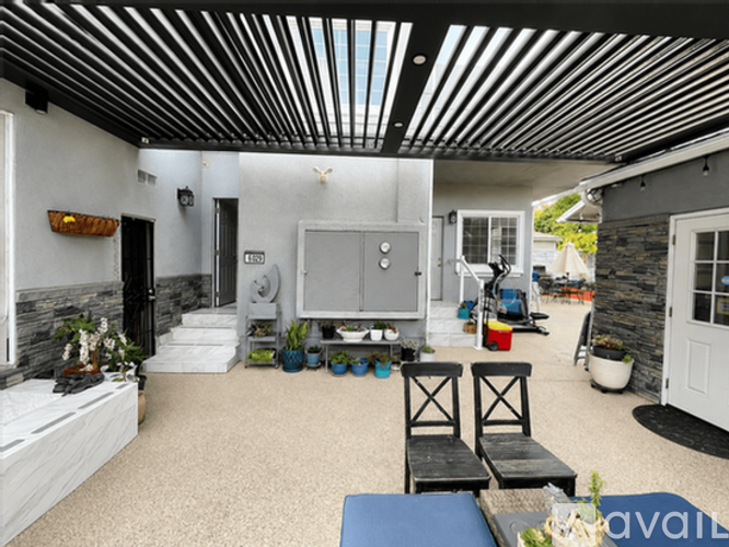 A living room with a white sofa and a black and white striped ceiling.
