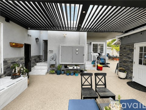 A living room with a white sofa and a black and white striped ceiling.