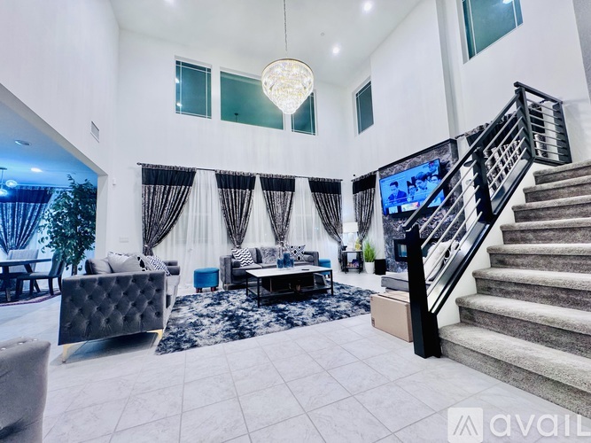 A bedroom with a bed, nightstand, and wall decorations.
