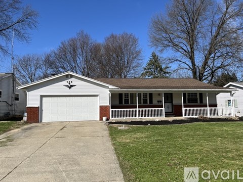 A house with a garage and a porch is for sale.
